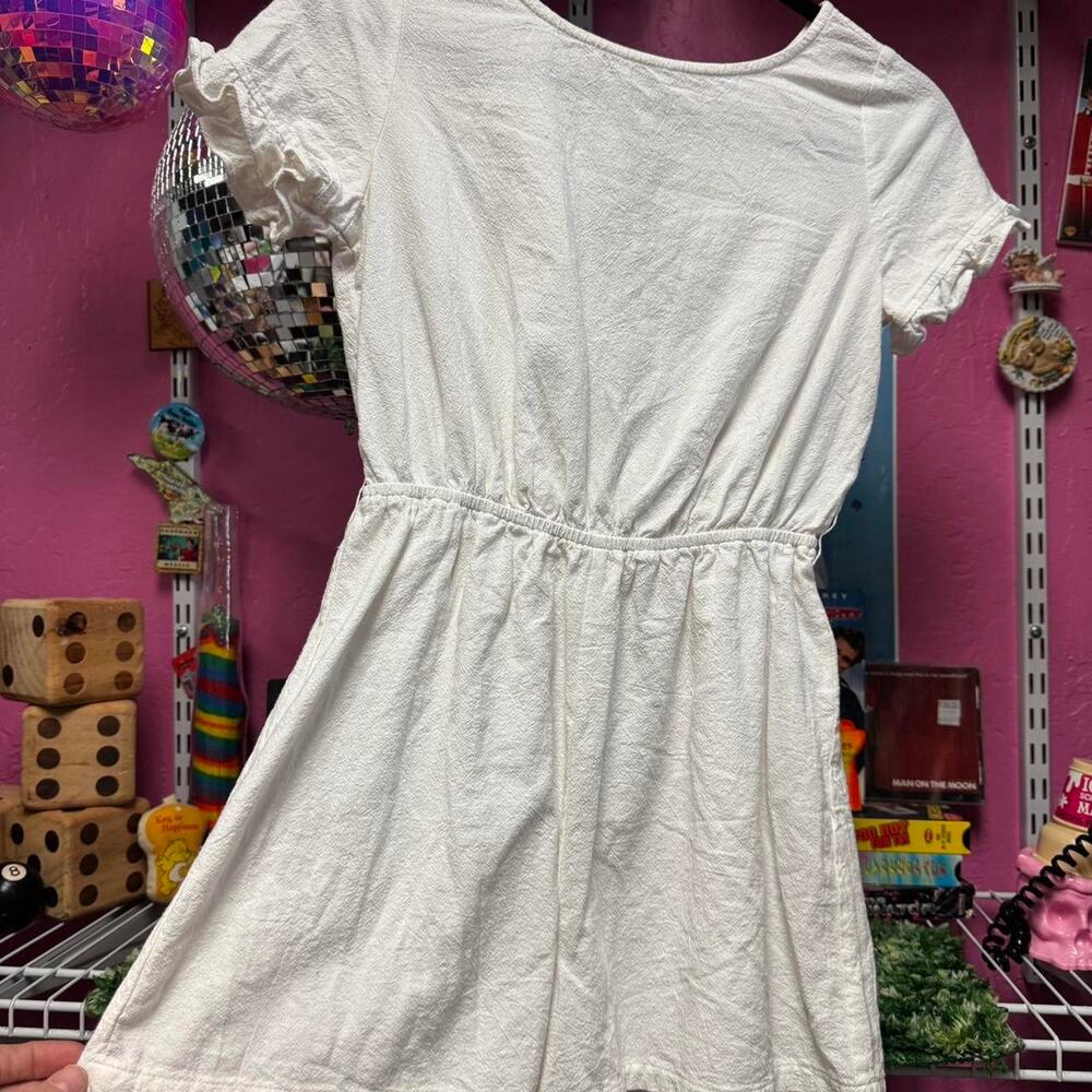 White linen romper with ruffle